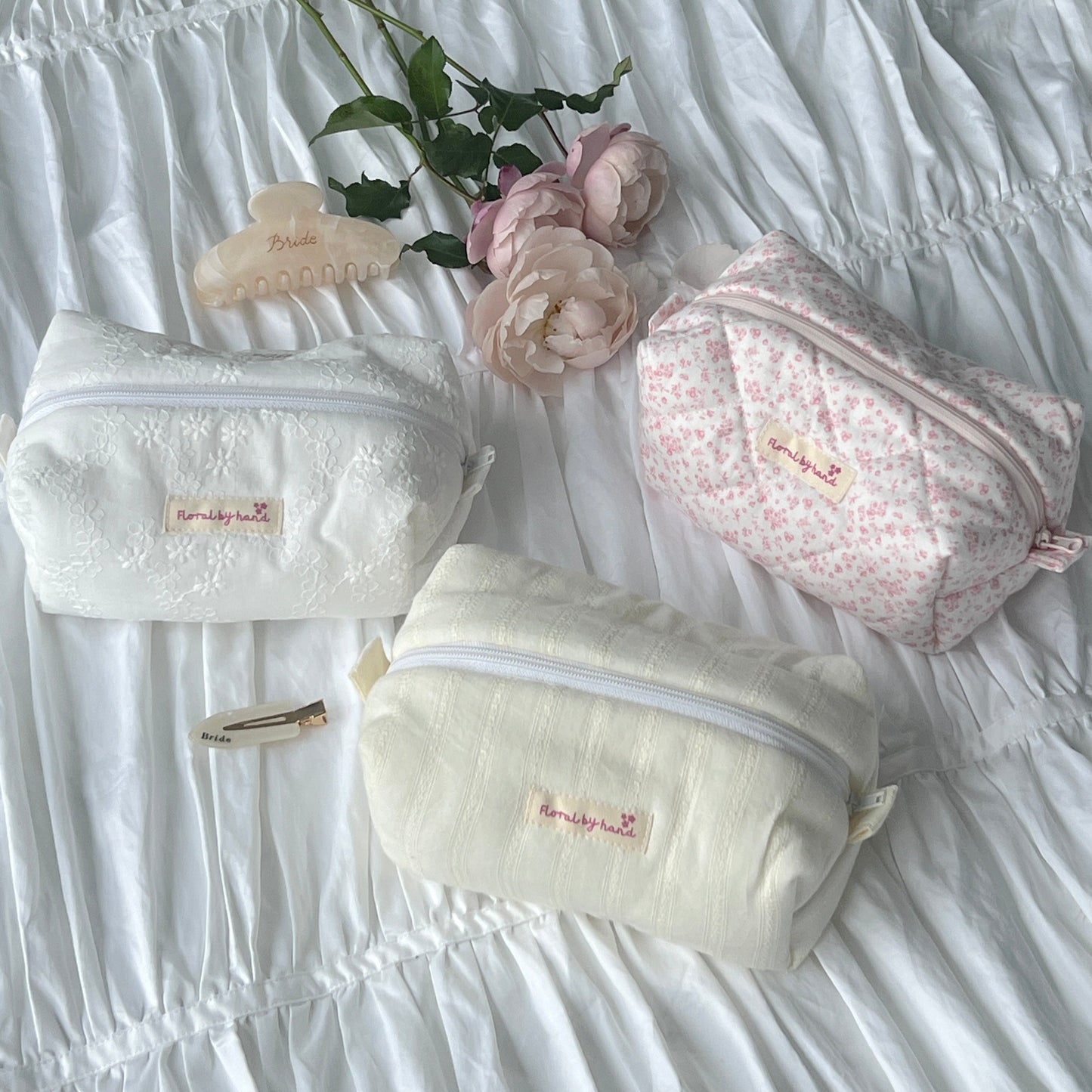 handmade soft quilted pastel pink cosmetic pouch with personalized embroidery name customization pinterest aesthetic coquette ballerina core makeup bag beauty case vanity girly feminine minimalism princess barbie bridesmaids gift ideal outfit white lace pastel yellow butter lace