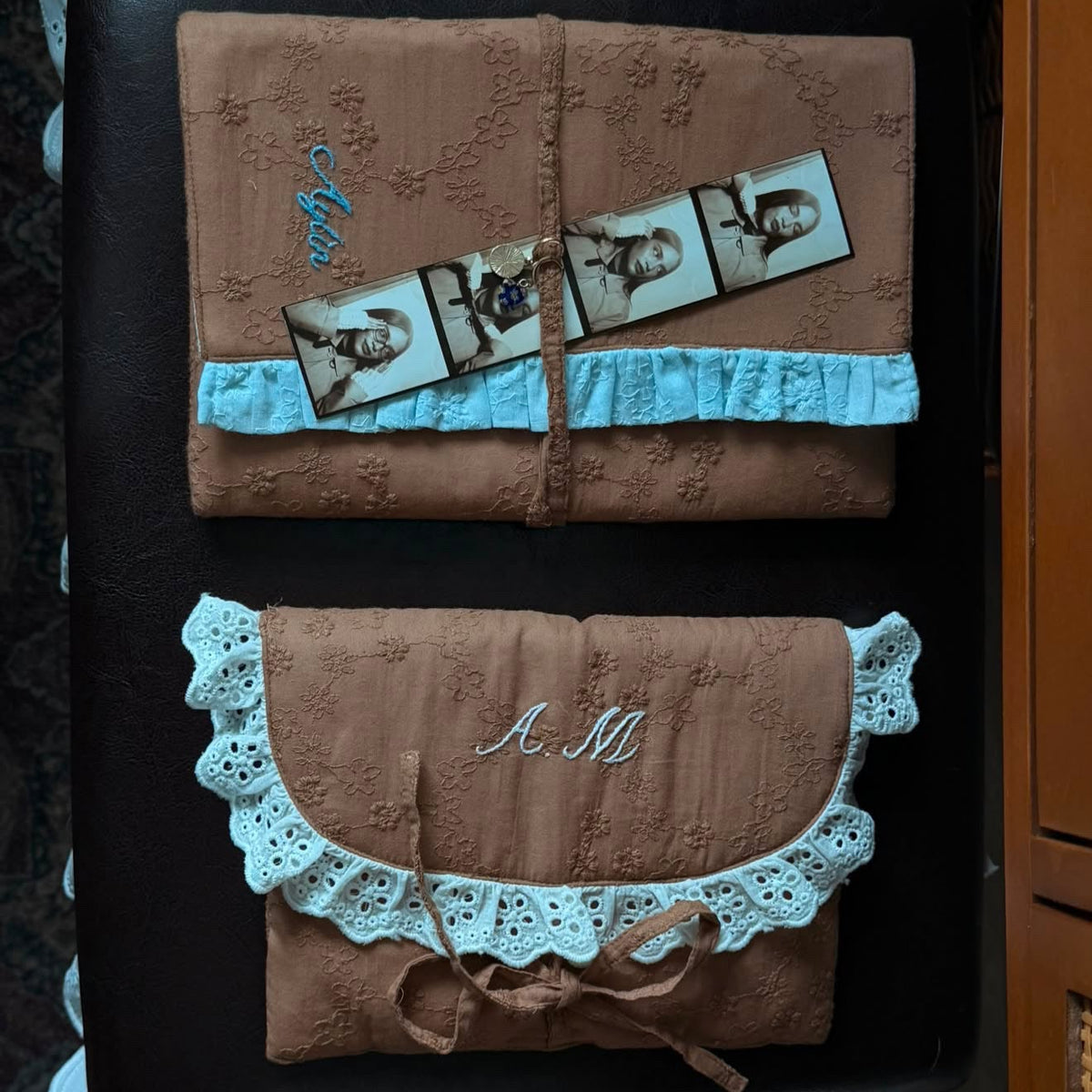Handmade brown quilted letter pouch with baby blue ruffles and floral lace embroidery, available as a cosmetic pouch, A5 book sleeve and padded iPad sleeve.