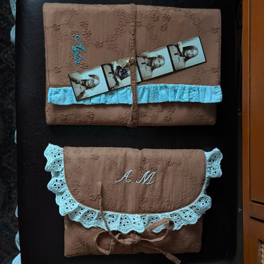 Handmade brown quilted letter pouch with baby blue ruffles and floral lace embroidery, available as a cosmetic pouch, A5 book sleeve and padded iPad sleeve.
