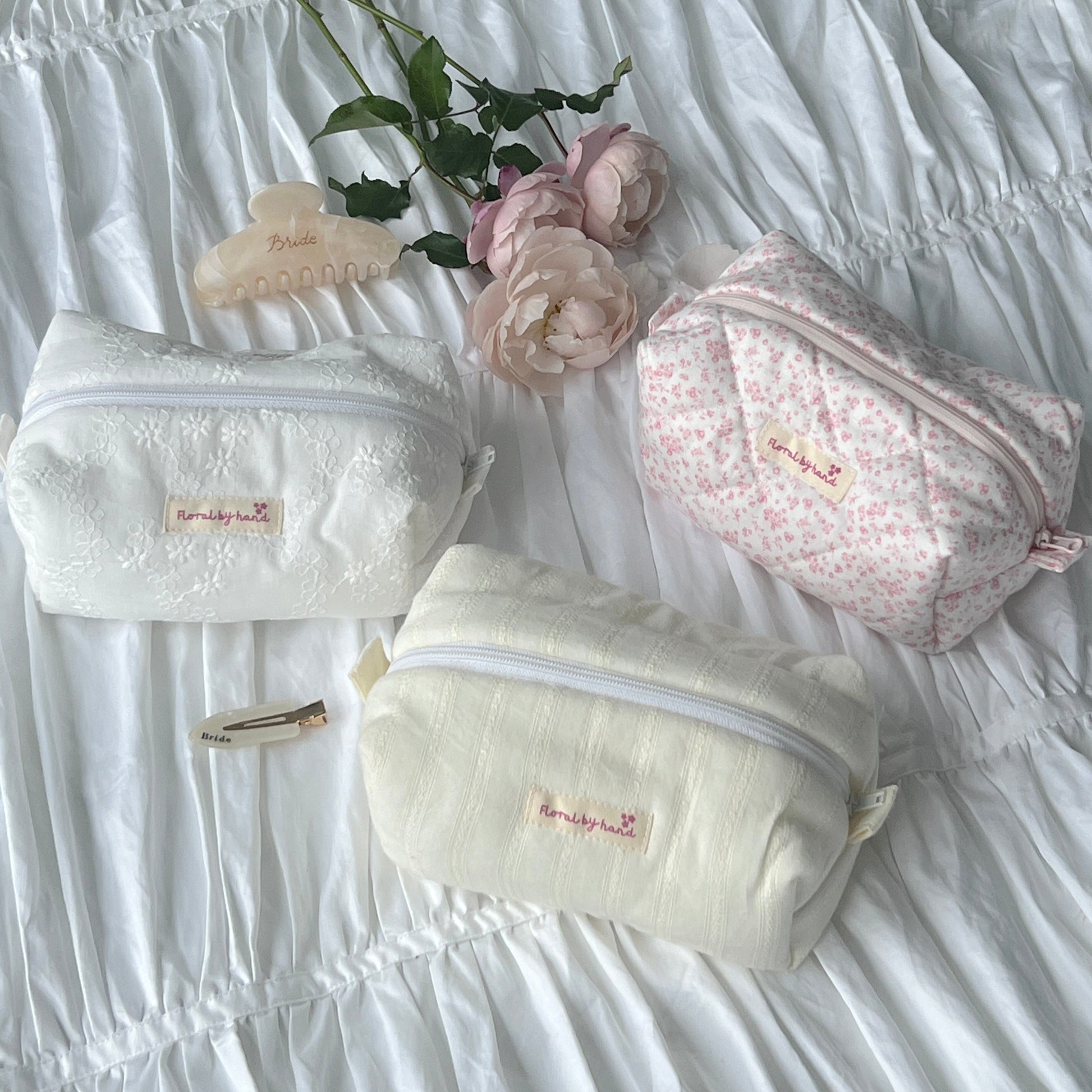 handmade soft quilted pastel pink cosmetic pouch with personalized embroidery name customization pinterest aesthetic coquette ballerina core makeup bag beauty case vanity girly feminine minimalism princess barbie bridesmaids gift ideal outfit white lace pastel yellow butter lace 